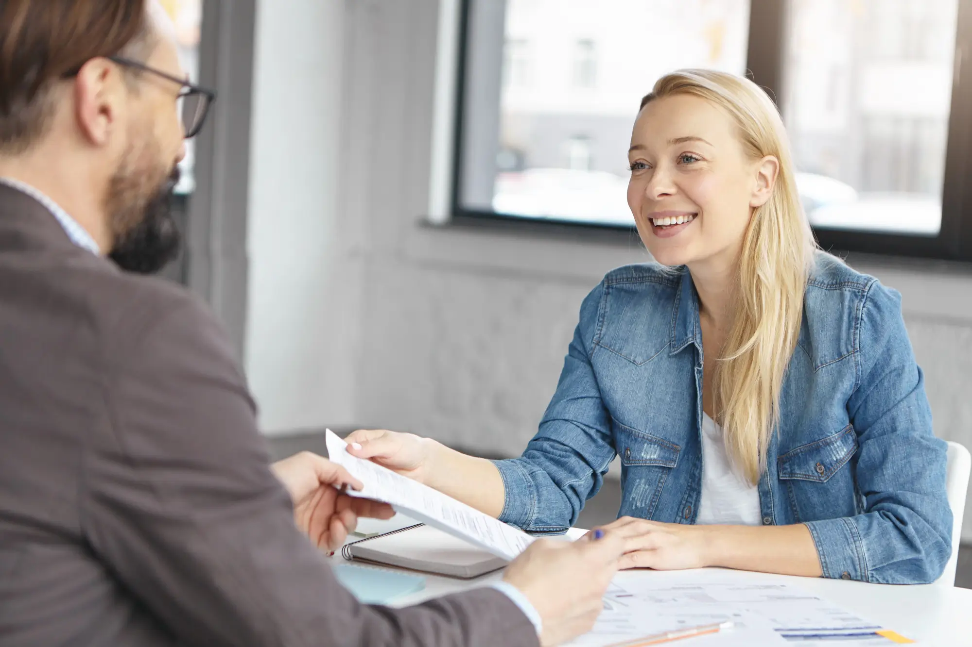 blonde female accountant has conversation with a client