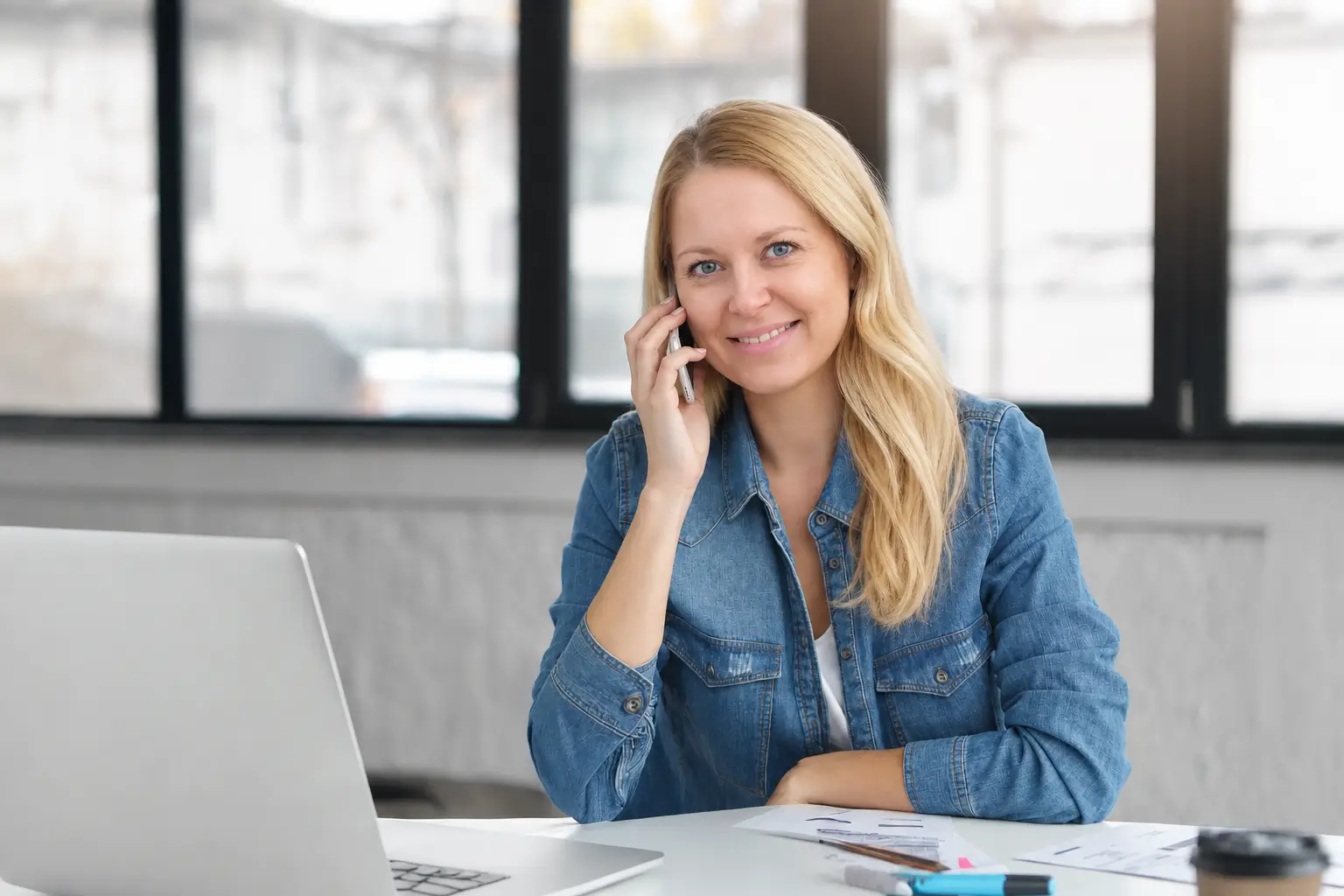 woman with phone in office